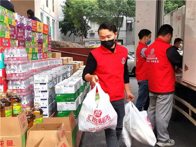 近日，区慈善会志愿服务大队志愿者为居民送蔬菜、米、油等生活物资。